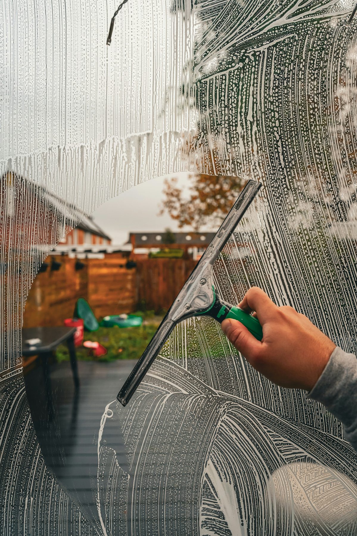 Squeegee cleaning soap from a residential window