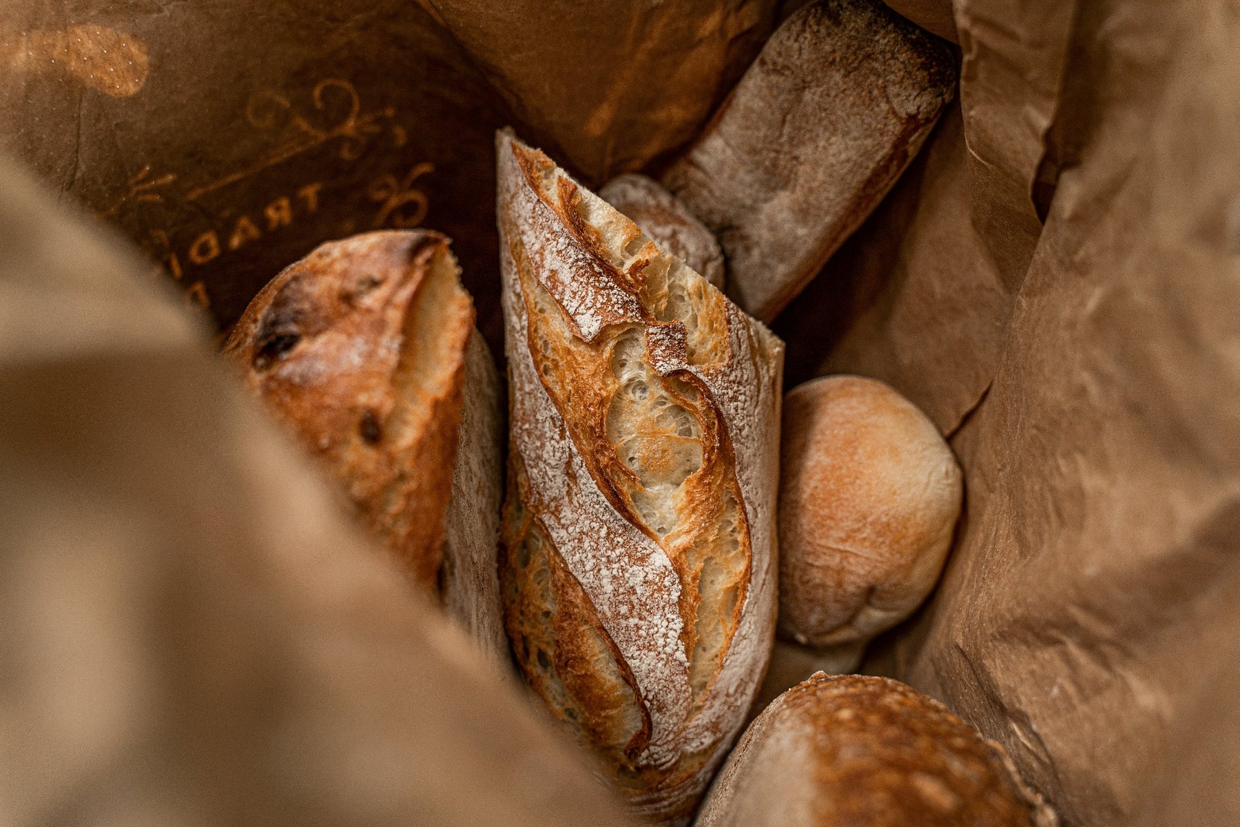 Fresh bread packed in a paper bakery bag