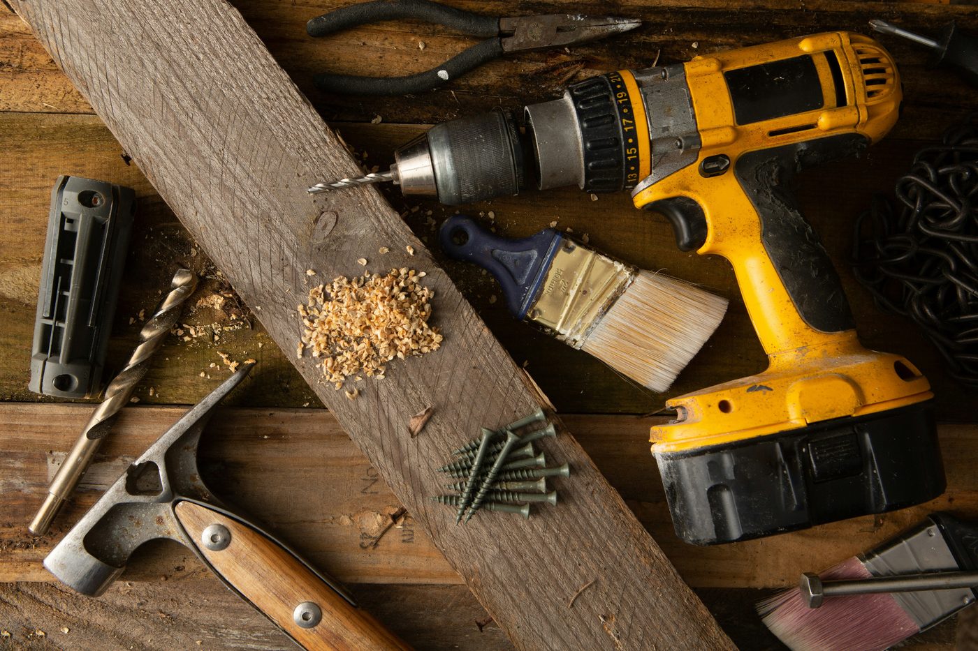 Power drill and tools on a wood bench