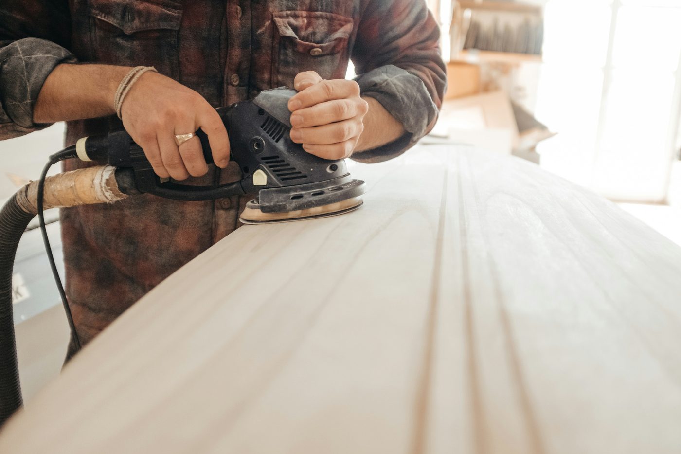 Sanding a long timber board